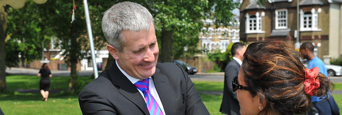 An image of Rob Perrins speaking to someone at a charity event