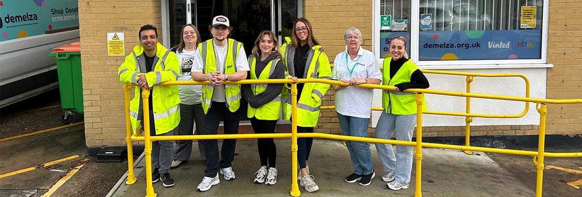 An image of people stood outside of the Demelza website