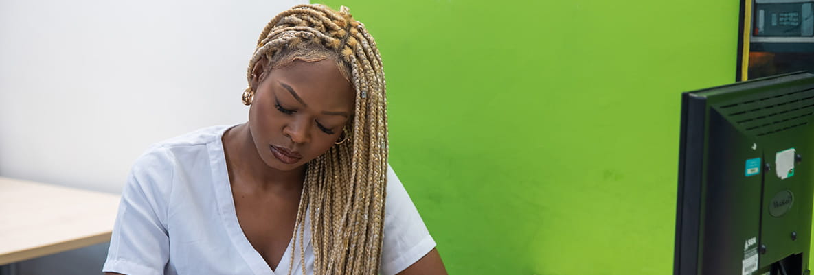 An image of a woman writing stuff down on a piece of paper