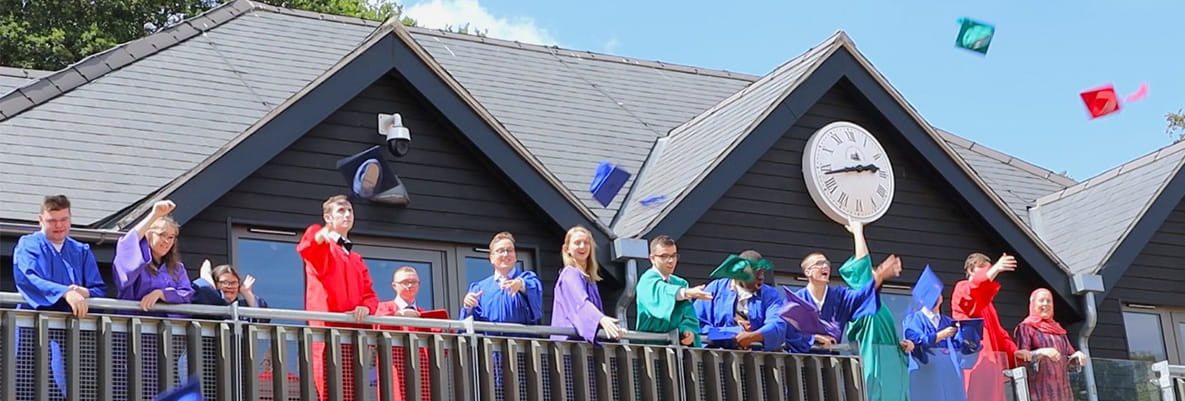 Members of the charity Mission EmployAble celebrating on a balcony