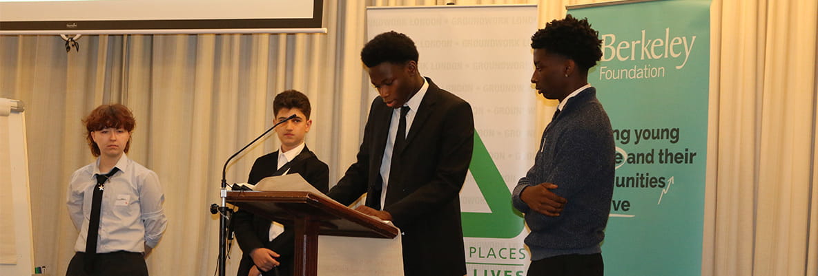 Youths at a speaking rally on stage supported by Berkeley Foundation.