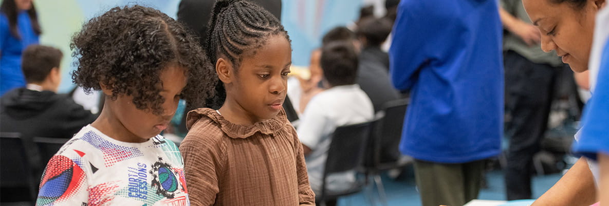 An image of people giving food to children