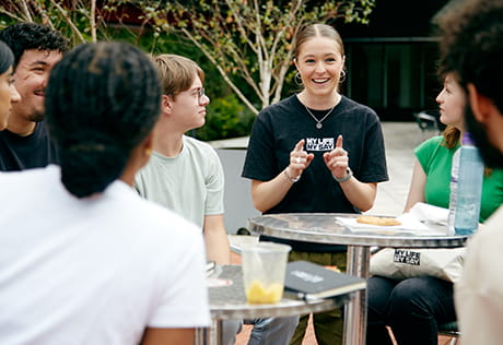 An image of Young People sat around together talking