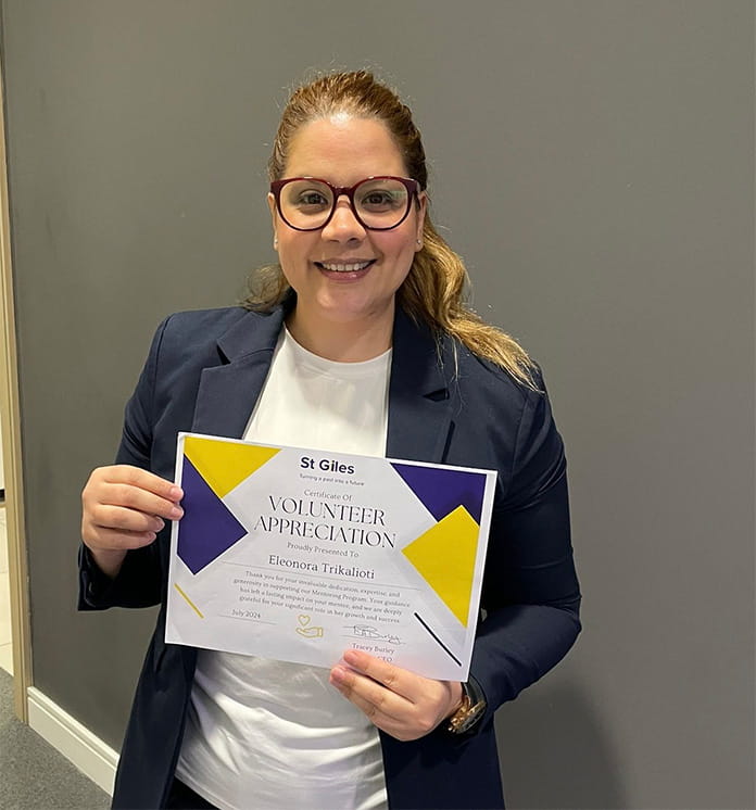 An image of Eleonora holding her mentoring certificate