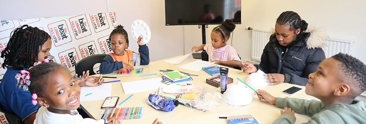 An image of young people sat around a table