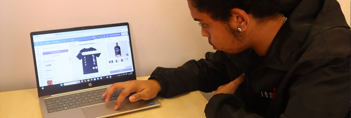 An image of a young person on a laptop