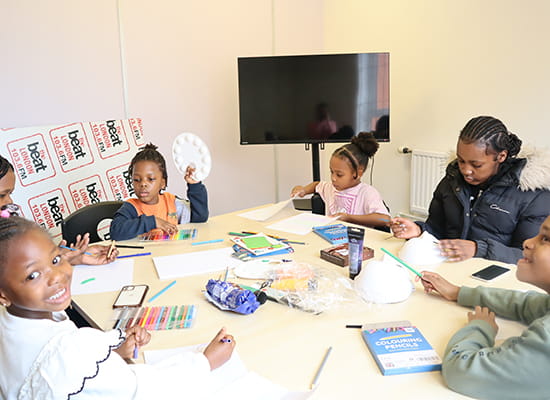 An image of young people sat around a table
