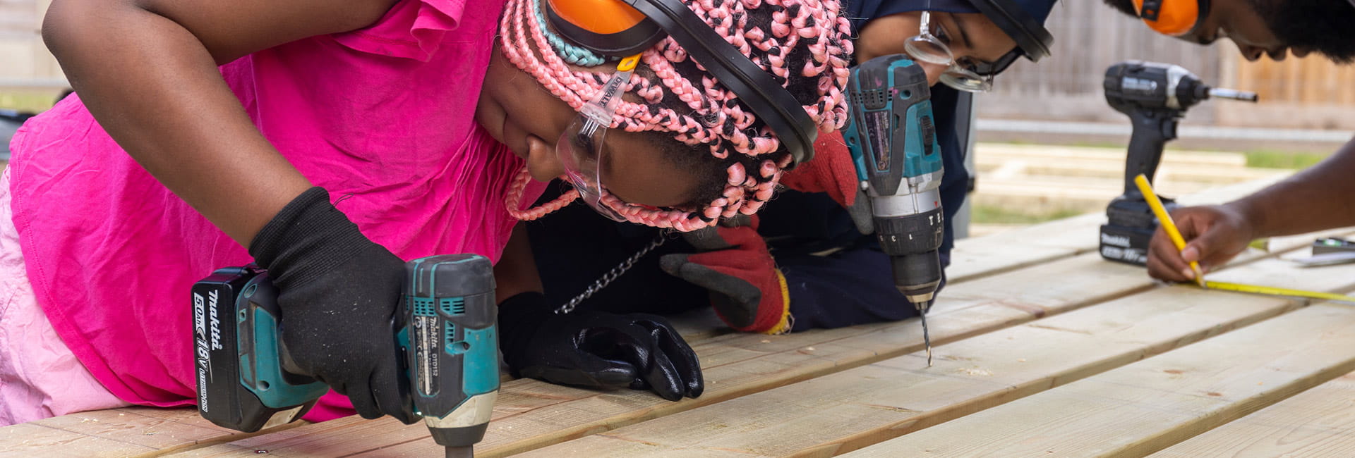 An image of people using power tools