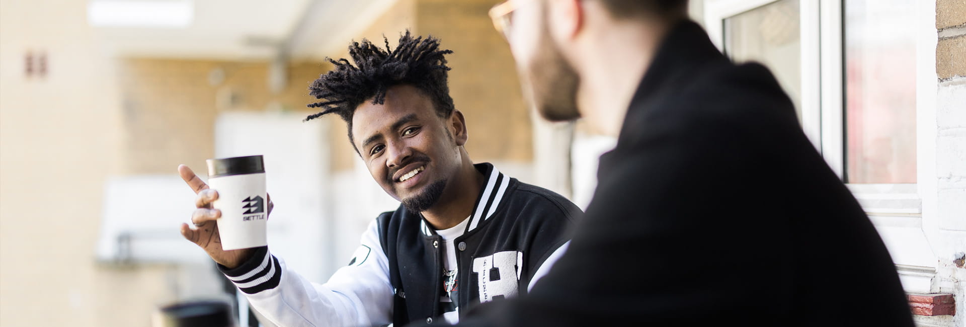 An image of someone talking to a person from Settle